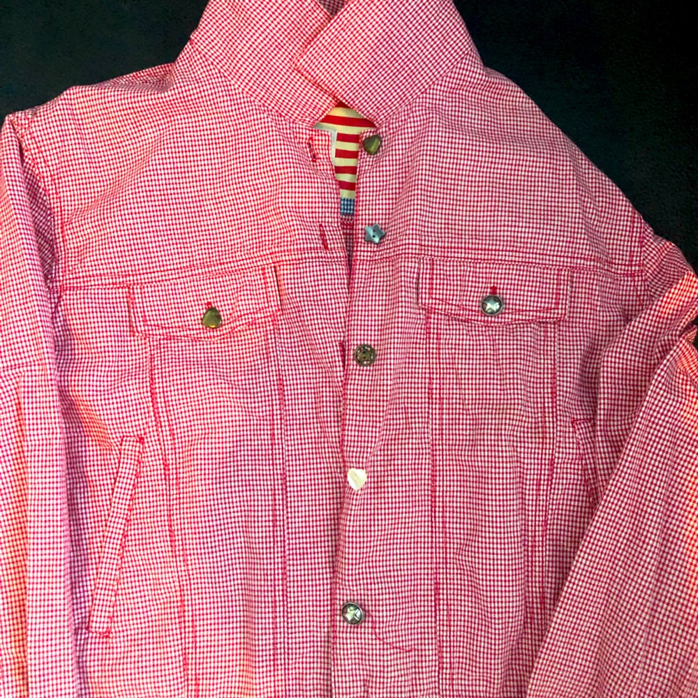 100% cotton denim style jacket. Unique button trim.
